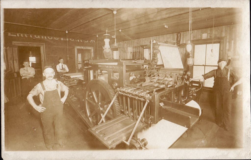 A vintage letterpress print shop with a large press